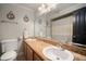 Bathroom featuring a double sink vanity with a granite countertop and framed mirror at 18712 Lakeshore Dr, Lutz, FL 33549