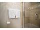 Bathroom with a glass door shower, two towels, and a toilet paper holder at 18712 Lakeshore Dr, Lutz, FL 33549