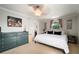 Bedroom with a dresser, bed, ceiling fan, dark trim, and light colored walls at 18712 Lakeshore Dr, Lutz, FL 33549