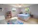 Bedroom with a bed, ceiling fan, two windows, a doll house, and carpeted floors at 18712 Lakeshore Dr, Lutz, FL 33549
