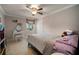 Bedroom with a ceiling fan, a doll house, and a vanity with a cushioned seat at 18712 Lakeshore Dr, Lutz, FL 33549