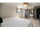 Cozy bedroom with neutral walls, a large mirror on the wall, and a ceiling fan at 18712 Lakeshore Dr, Lutz, FL 33549