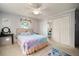 Bedroom with a bed, a ceiling fan, closet doors, a vanity, and carpeted floors at 18712 Lakeshore Dr, Lutz, FL 33549