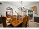 Elegant dining room with a large table, chandelier, and access to an outdoor area at 18712 Lakeshore Dr, Lutz, FL 33549