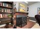 Office/den fireplace with custom bookshelves, hearth and decorative screen at 18712 Lakeshore Dr, Lutz, FL 33549
