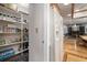 Spacious walk-in pantry, refrigerator, and eat-in kitchen with wood flooring at 18712 Lakeshore Dr, Lutz, FL 33549