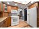 Updated kitchen features wood cabinets, granite countertops, stainless steel appliances, and refrigerator at 18712 Lakeshore Dr, Lutz, FL 33549