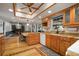 Spacious kitchen with wood cabinets, granite countertops, and open access to the dining and living areas at 18712 Lakeshore Dr, Lutz, FL 33549