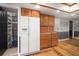 Spacious kitchen with walk-in pantry, stainless steel refrigerator, and wood cabinets at 18712 Lakeshore Dr, Lutz, FL 33549
