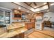 Bright kitchen featuring wooden cabinets, granite countertops, and a convenient breakfast bar at 18712 Lakeshore Dr, Lutz, FL 33549
