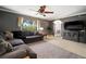 Cozy living room with comfortable seating, natural light and a media center at 18712 Lakeshore Dr, Lutz, FL 33549