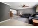 Comfortable living room featuring a large sectional sofa, and natural light at 18712 Lakeshore Dr, Lutz, FL 33549