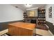 Office/den with custom bookshelves, plush carpet and decorative fireplace at 18712 Lakeshore Dr, Lutz, FL 33549