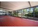 Spacious screened-in patio with a hot tub and views of the backyard and pond at 18712 Lakeshore Dr, Lutz, FL 33549