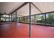Large screened-in porch has wood-look floors with hot tub and views of pond and backyard at 18712 Lakeshore Dr, Lutz, FL 33549