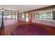 Covered outdoor porch featuring a hot tub, brick exterior and a wood floor creates a relaxing backyard oasis at 18712 Lakeshore Dr, Lutz, FL 33549