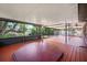 Spacious screened porch featuring a hot tub and wood-look floors offers an area for relaxation and entertainment at 18712 Lakeshore Dr, Lutz, FL 33549