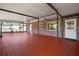 Spacious enclosed patio with concrete pillars, ceiling fans, and a door leading to the backyard at 18712 Lakeshore Dr, Lutz, FL 33549