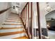 Staircase with wood railings leading to the upper level of the home at 18712 Lakeshore Dr, Lutz, FL 33549