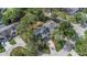 An aerial view of the house shows the roof line, mature trees, and surrounding neighborhood streets at 200 Pinewinds Blvd, Oldsmar, FL 34677