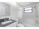Bright bathroom features a shower and tub combination with a large vanity and mirrored medicine cabinet at 200 Pinewinds Blvd, Oldsmar, FL 34677