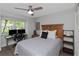 Bedroom showcasing a wood headboard, desk area, and ample natural light from the window at 200 Pinewinds Blvd, Oldsmar, FL 34677
