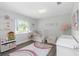 Charming Bedroom features a crib, rainbow rug, and playful decor, creating a cozy and inviting space at 200 Pinewinds Blvd, Oldsmar, FL 34677