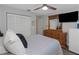 Cozy bedroom features a ceiling fan, dresser, and a closet with white doors, offering ample storage at 200 Pinewinds Blvd, Oldsmar, FL 34677