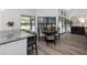 Bright dining area features a round table, stylish chairs, and natural light from large windows at 200 Pinewinds Blvd, Oldsmar, FL 34677