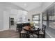Dining area with round table, modern chairs, and seamless flow into the contemporary kitchen at 200 Pinewinds Blvd, Oldsmar, FL 34677