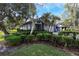 Charming single-story home featuring lush landscaping and a well-maintained lawn on a sunny day at 200 Pinewinds Blvd, Oldsmar, FL 34677