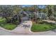 Charming single-story home featuring a well-manicured lawn, mature landscaping, and an attached two-car garage at 200 Pinewinds Blvd, Oldsmar, FL 34677