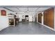 Spacious garage with ample storage, work area, and overhead lighting at 200 Pinewinds Blvd, Oldsmar, FL 34677