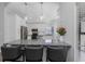 An updated eat-in kitchen has stainless appliances, new cabinets, and new countertops with barstool seating at 200 Pinewinds Blvd, Oldsmar, FL 34677