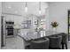 Modern kitchen with granite countertops, stainless steel appliances, new white cabinets, and barstool seating at 200 Pinewinds Blvd, Oldsmar, FL 34677