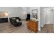 A well-lit living room offers an oversized sofa, hardwood floors, chandelier lighting, and neutral paint at 200 Pinewinds Blvd, Oldsmar, FL 34677