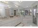 Bright main bathroom featuring a dual sink vanity, a soaking tub, and a walk-in shower at 200 Pinewinds Blvd, Oldsmar, FL 34677