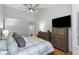 Spacious main bedroom with a ceiling fan, large bed and lots of storage in a neutral color palette at 200 Pinewinds Blvd, Oldsmar, FL 34677