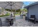 Private patio area with stylish stone pavers, seating, and gated entrance at 200 Pinewinds Blvd, Oldsmar, FL 34677