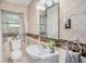Tiled bathroom with modern fixtures and a decorative mirror at 202 W Azalea Ave, Tampa, FL 33612