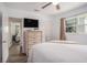 This bedroom features a ceiling fan, window, and closet at 202 W Azalea Ave, Tampa, FL 33612
