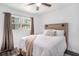 Bright bedroom with a ceiling fan, window, and hardwood headboard at 202 W Azalea Ave, Tampa, FL 33612