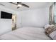 Bright bedroom featuring a ceiling fan, mounted television, and white walls at 202 W Azalea Ave, Tampa, FL 33612