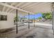 View from inside the covered carport, showing the driveway and the front of the property at 202 W Azalea Ave, Tampa, FL 33612