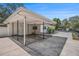 Spacious covered carport attached to a white single-story house with concrete flooring at 202 W Azalea Ave, Tampa, FL 33612