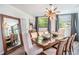 Elegant dining room featuring a large table, stylish chandelier, and ample natural light at 202 W Azalea Ave, Tampa, FL 33612