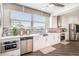 Modern kitchen with white cabinetry, stainless steel appliances, and mosaic tile backsplash at 202 W Azalea Ave, Tampa, FL 33612