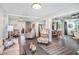 Open-concept living area with stylish furniture, wood floors, and seamless flow to dining area at 202 W Azalea Ave, Tampa, FL 33612