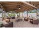 Covered patio features multiple seating arrangements with comfortable furniture and ceiling fans at 202 W Azalea Ave, Tampa, FL 33612