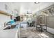 Bright, screened-in sunroom featuring tile floors, a dining area, and an outdoor kitchen with white cabinets at 202 W Azalea Ave, Tampa, FL 33612